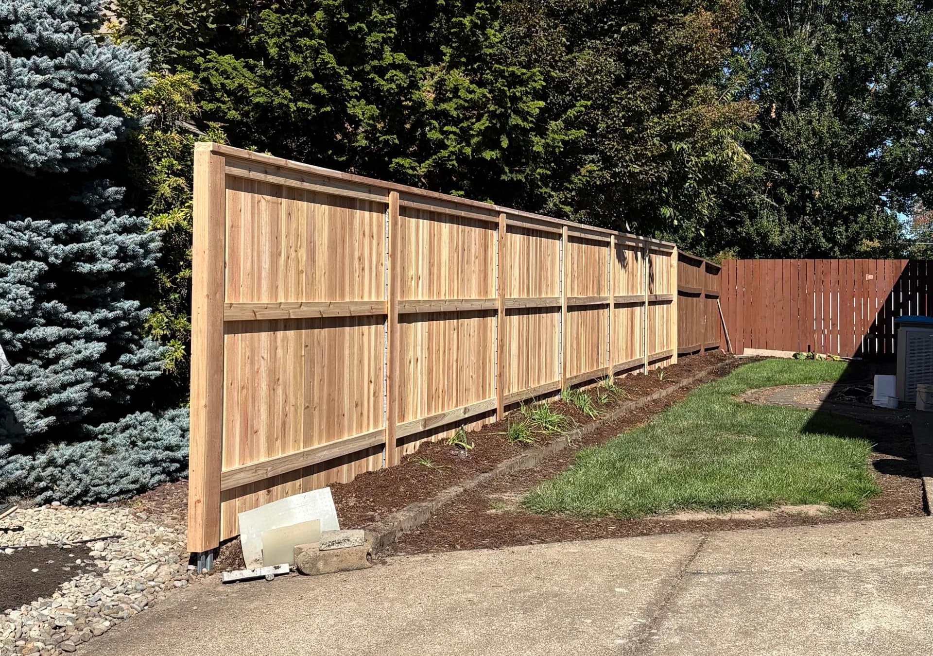 Japanese cedar picket fence detail on steel PostMaster posts set in concrete